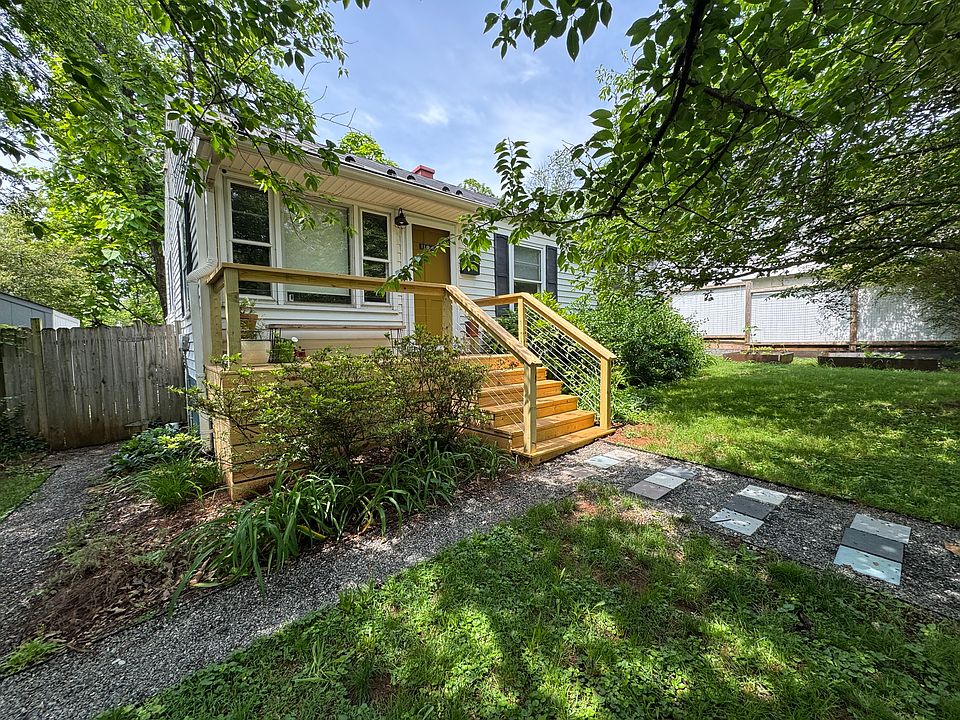 View of front door and new wooden front porch.