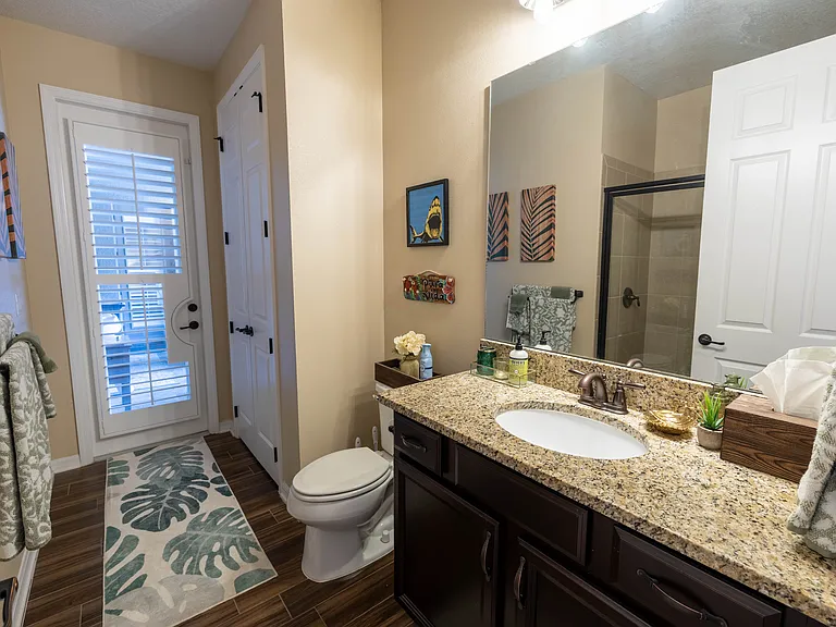 Hallway Bathroom with Entrance to Lanai and Pool