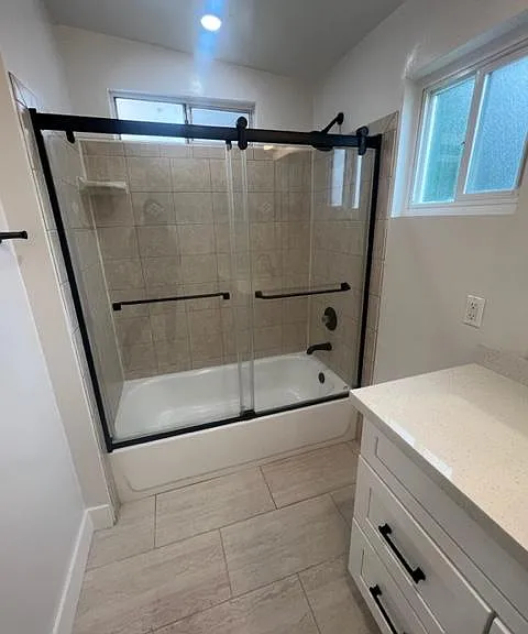 en suite bath with glass shower doors
