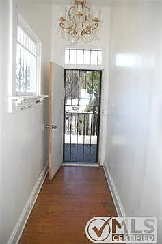 Historic entry, wood floors, classic lighting in this San Diego home