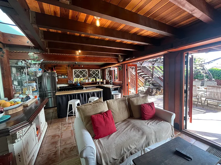 Redwood Room and kitchen with open folding wooden doors to patio
