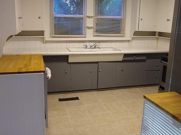Kitchen with stainless appliances, new dishwasher, cabinets and counter tops.