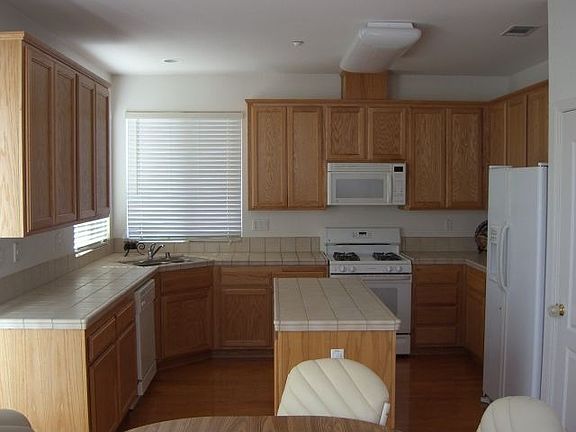 Kitchen has tile counters