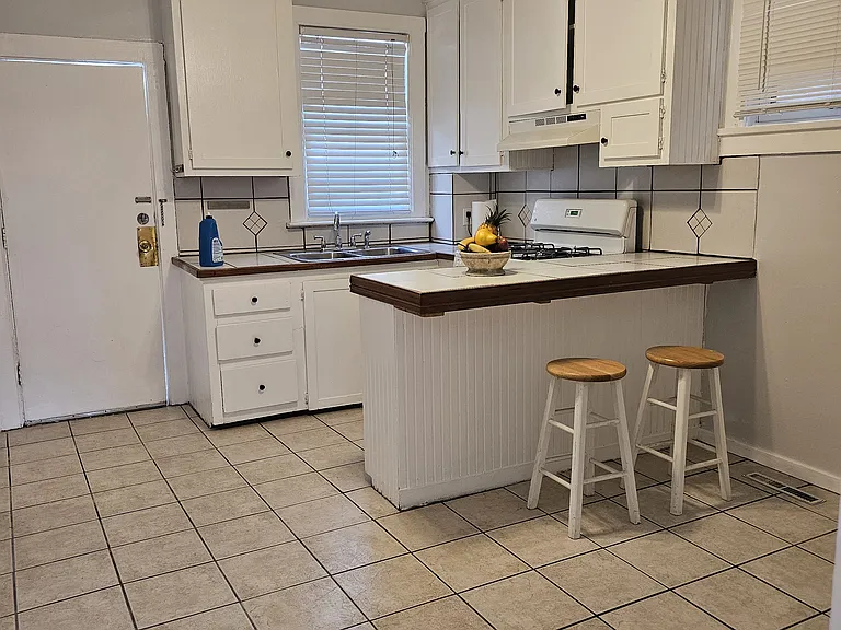 Kitchen with dining area. Refrigerator is at the far end and can be relocated.