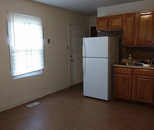 Back Door enters to Kitchen and continues to basement