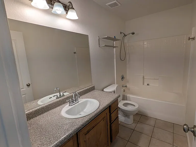 Move-in-ready bathroom serving the guest wing.