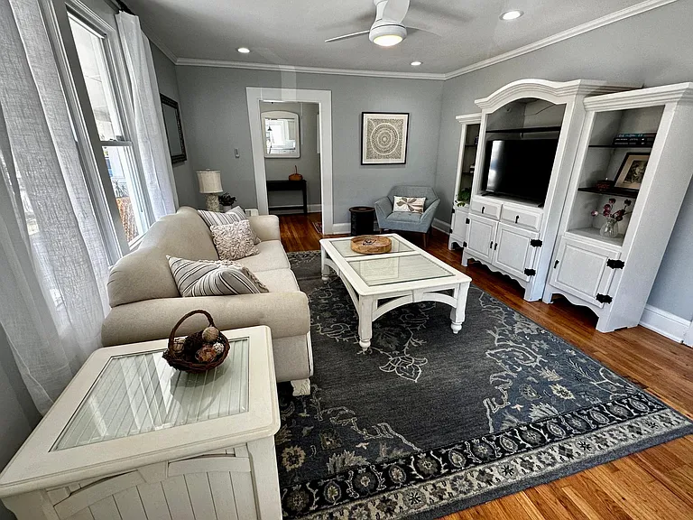 Living room with view to foyer entrance