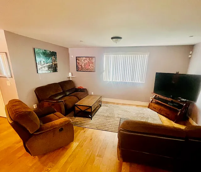 Living Room has Ceiling fan, Reclining couches, Flat screen TV w/ Fire-stick and two work spaces w/ Hi-speed WiFi.