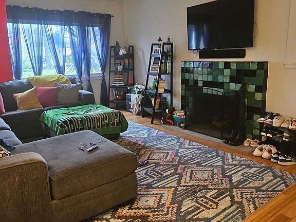 Living room with working fireplace and huge open windows.