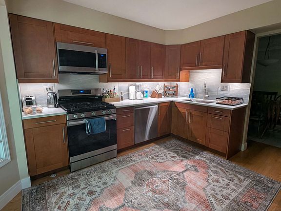 Spacious stainless-steel kitchen with wi-fi enabled appliances, all new