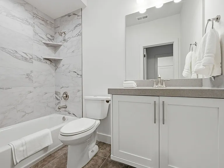 Full sized bathroom with shower and tub