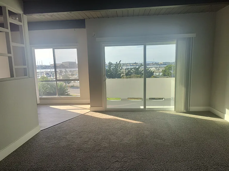 Living room and eat-kitchen with extra large spacious windows and private balcony overlooking Marina