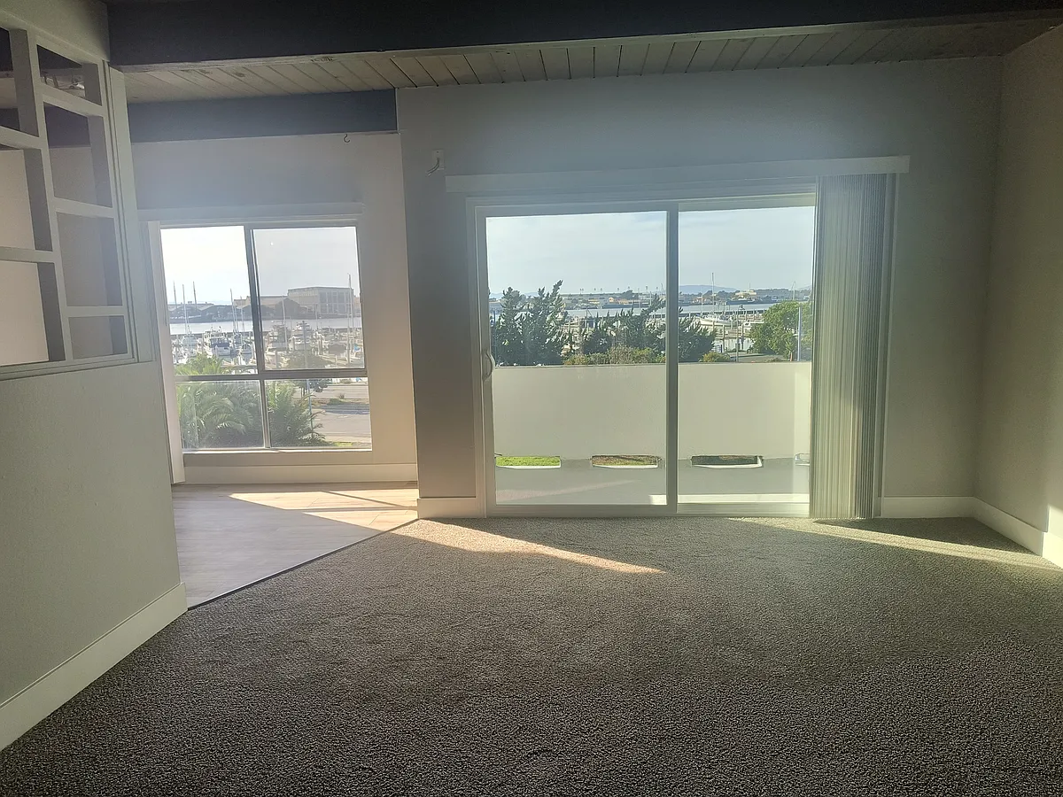 Living room and eat-kitchen with extra large spacious windows and private balcony overlooking Marina - 690 Mare Island Way