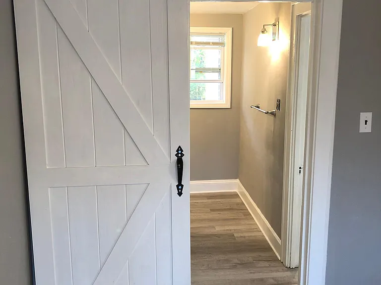 Barn door leading into bathroom