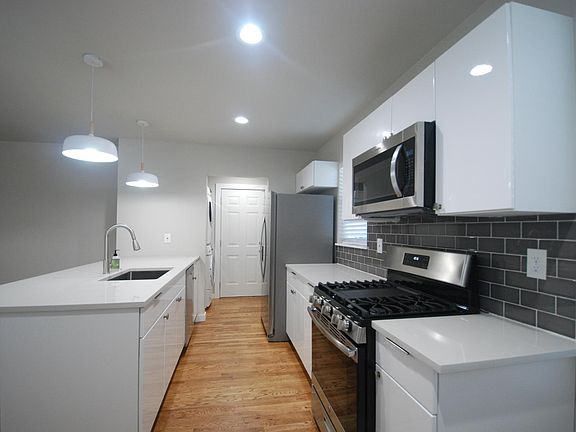 All new high end kitchen with a modern flair. Counter height bar for entertaining guests while you cook. Stainless gas range for the gourmet cook. Extra large refrigerator.