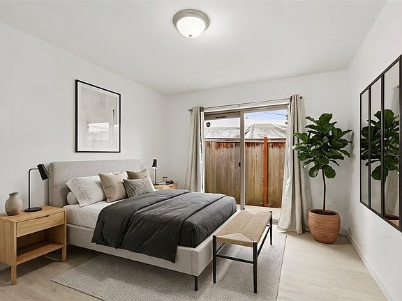 Lower-level bedroom with ensuite full bath and direct connection to the patio area.