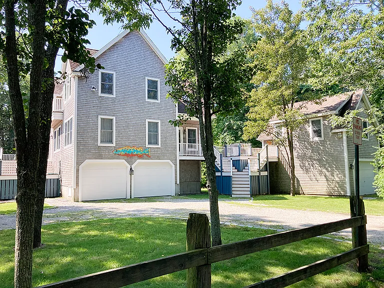 Lothrop Lane view of the main House and detached Studio apartment. There is a hot-cold outdoor shower to the left of the garage of the Main house.