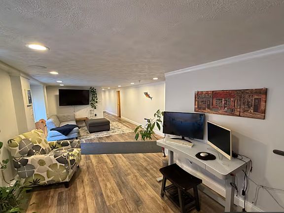 Another view of the open living space featuring a large TV setup and direct access to the outdoors.