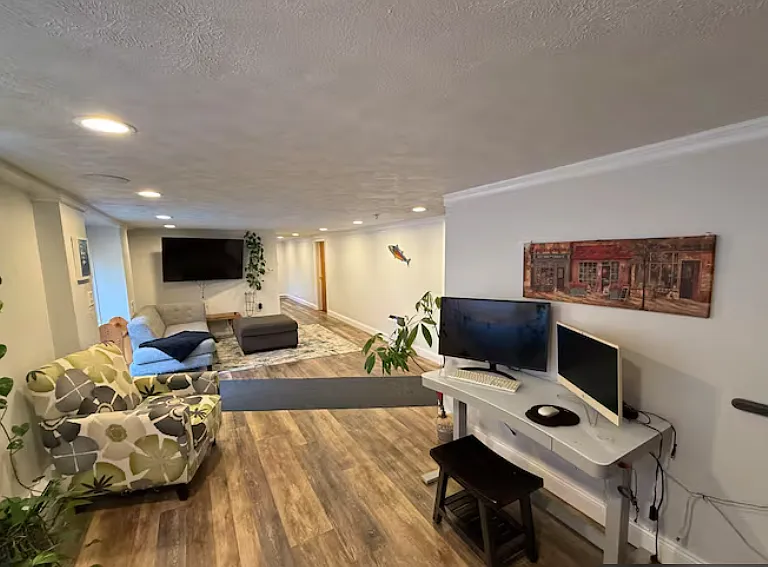 Another view of the open living space featuring a large TV setup and direct access to the outdoors.