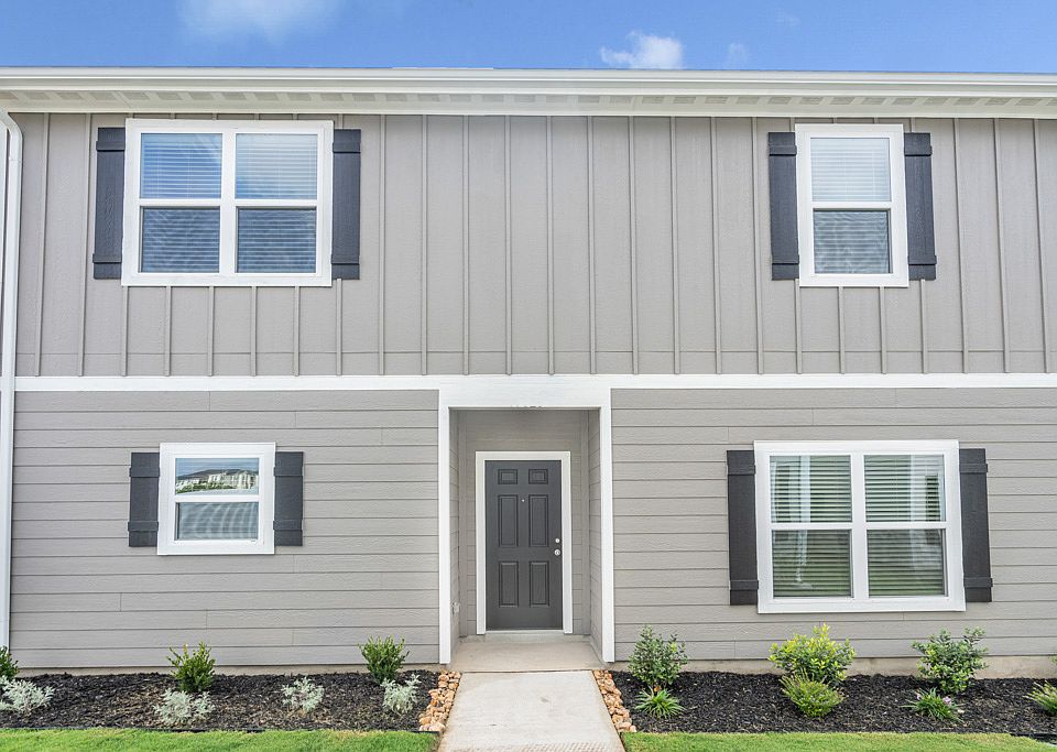 Exterior of the Young plan with professional front yard landscaping.