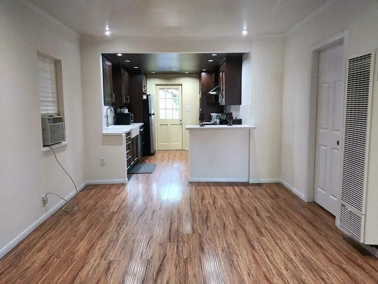 Living room/dining room and kitchen with bar seating.