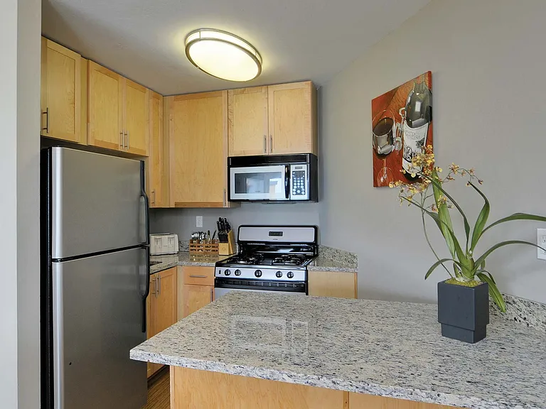 Bright and open kitchen with granite countertops and breakfast bar