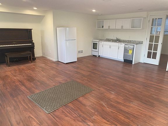 The main area has 2-3 living spaces, and this is a nuk that could be used as a seating area or dining area. The bedroom is behind the second set of double doors.