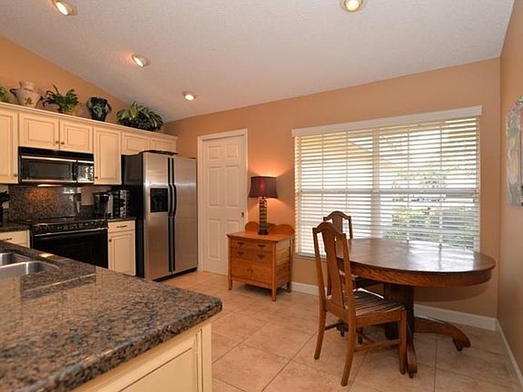 Eat-in kitchen with large window overlooking front yard.
