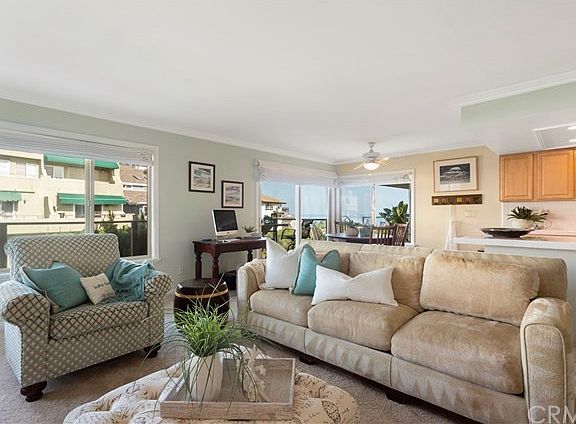 View of the spacious living room with beautiful windows and large deck with lovely Ocean View. The Ocean View is much better in 