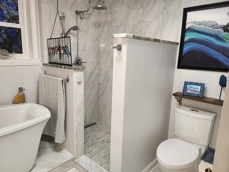 Master bath has open marble shower floor
