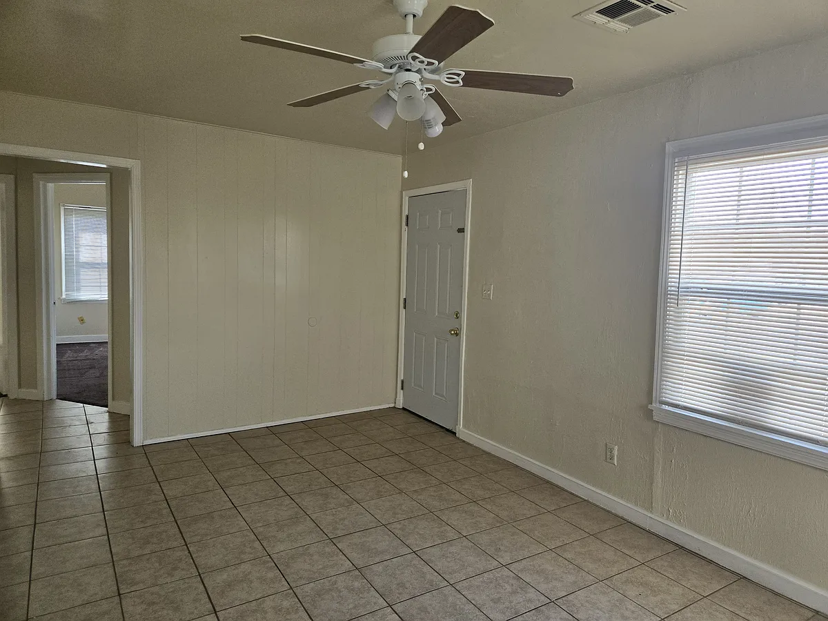Living room with view of Room 1 - 2124 S Air Depot Blvd