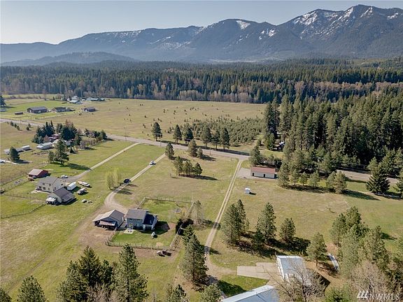 Detached 2 car garage has covered carport on east side for additional storage.  Covered area also off back of garage for wood cutting, storage, etc.