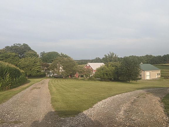 View from top of driveway. House sits at bottom of farm lane.