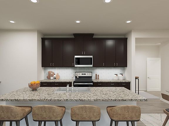 kitchen with dark wood cabinets and granite counter