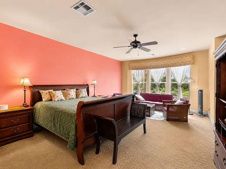 Master bedroom with a sitting area and 2 walk in closets.