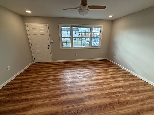 Living Room natural light. New cordless blinds on all windows. Recessed lighting & ceiling fan.