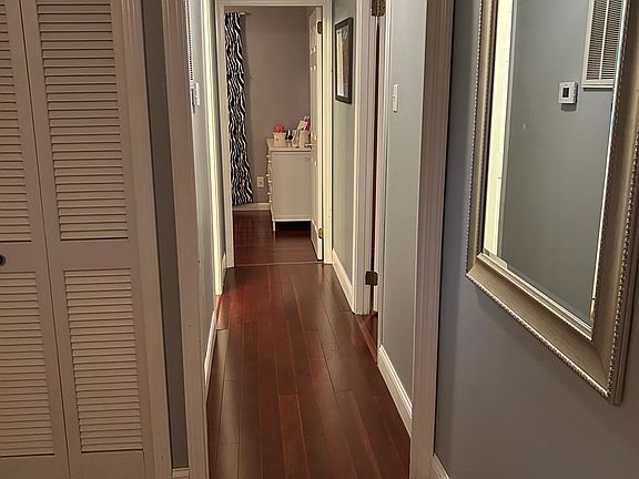 Hallway that leads from the front living space to the two bedrooms located at the front of the home, as well as one full bathroom.