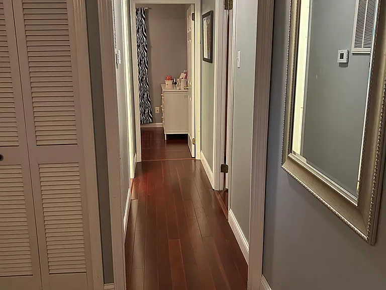 Hallway that leads from the front living space to the two bedrooms located at the front of the home, as well as one full bathroom.