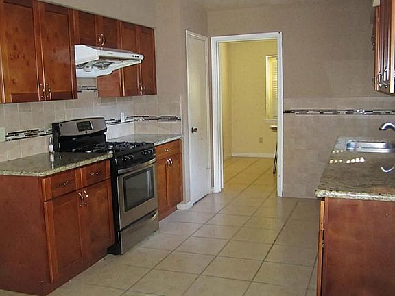 updated kitchen with granite counter top, updated faucet/ sink, updated stove/oven