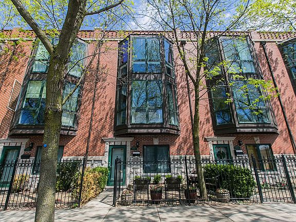 Exterior of the townhouse on Hoyne Ave. Fenced in front patio.
