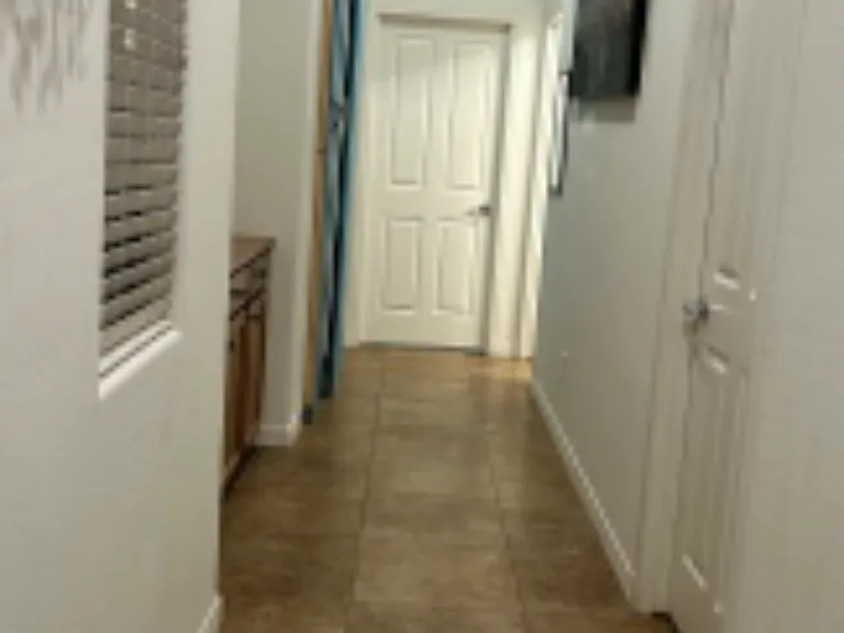 Hallway view showing closed sliding farmhouse door for added privacy. Nook includes coffee and tea maker.