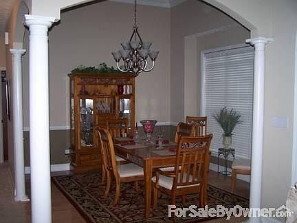 Great room with gas fireplace and open foyer.