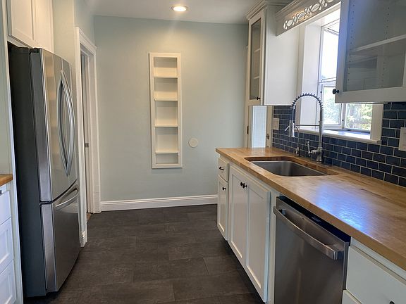 Galley kitchen with new appliances.