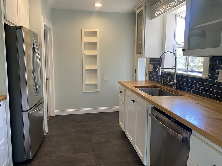 Galley kitchen with new appliances.