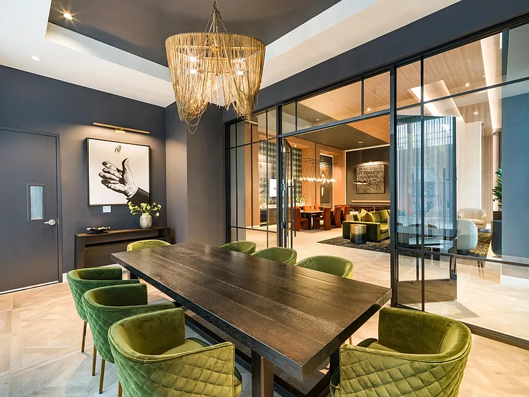 Layered textures, statement lighting, and tailored finishes create a conference room designed for focused meetings and elevated collaboration.