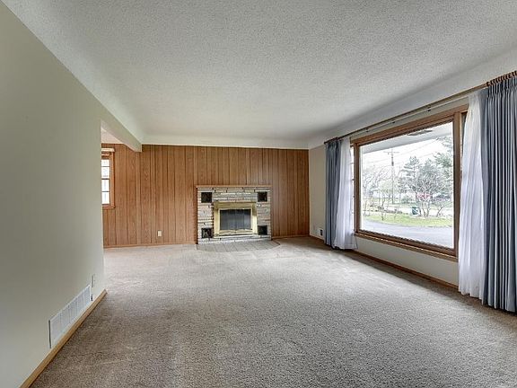Oversized Living room has oversized windows and the fireplace is a focal point.
