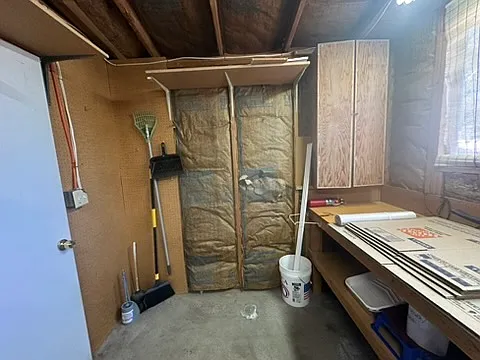 Outdoor shed with ladders, brooms, blower, etc.