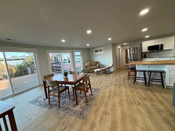 View of second living area, dining area and kitchen.