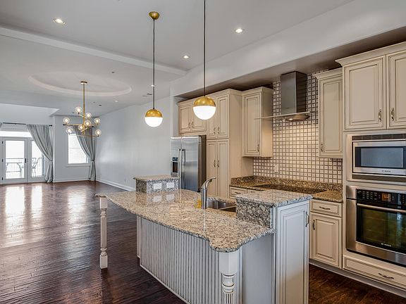 Open-concept kitchen with stone countertops and modern finishes