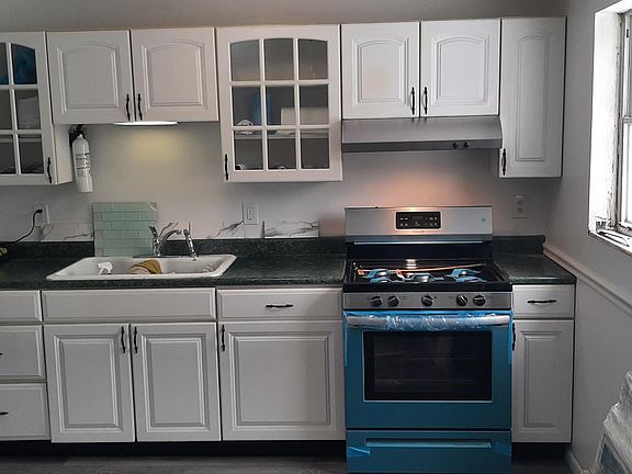 Galley kitchen with stainless appliances and backsplash options